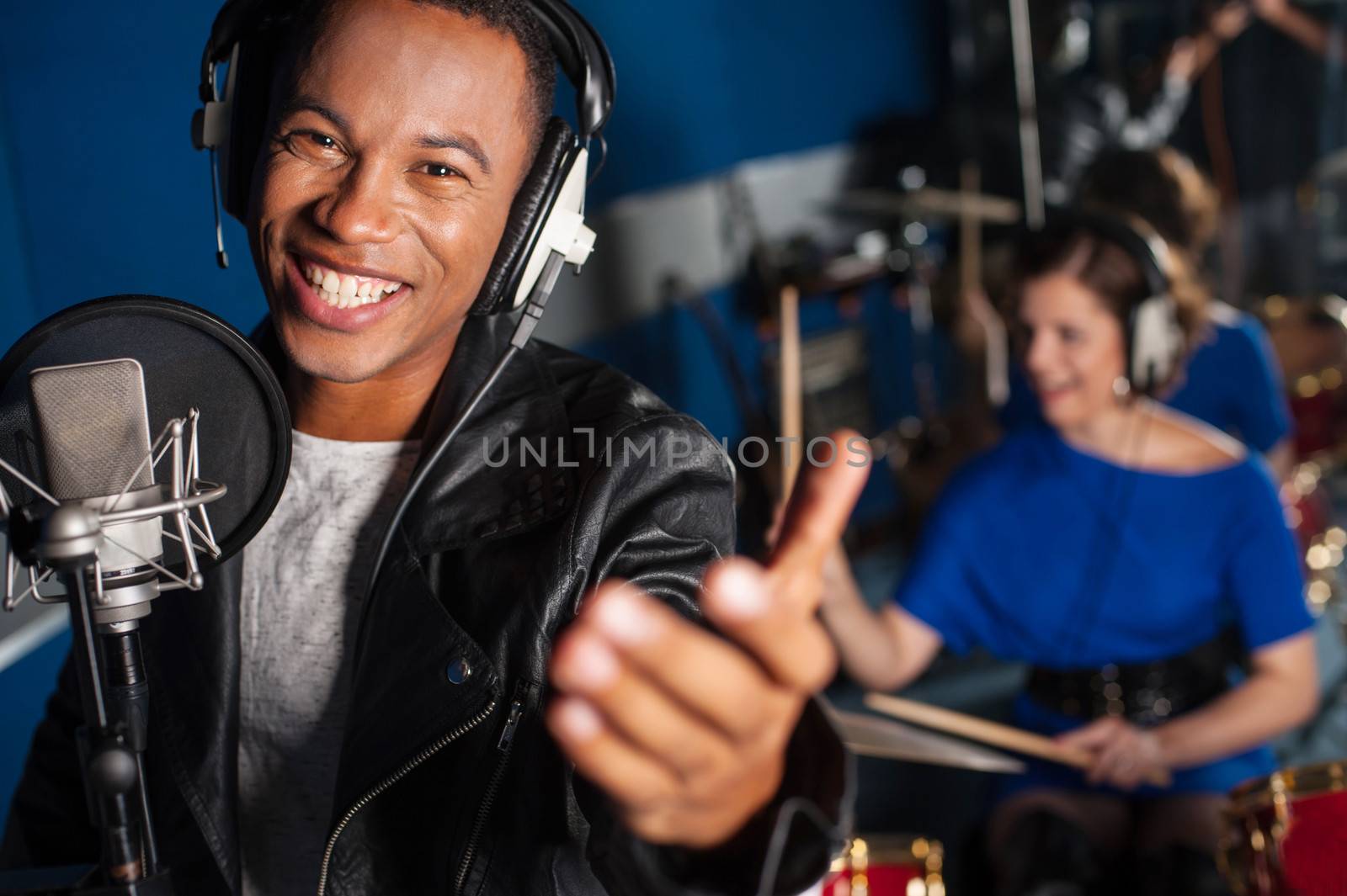 Young man singing in studio by stockyimages