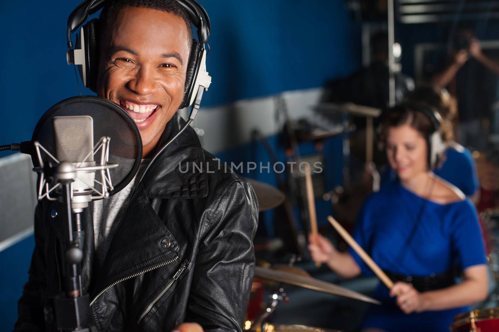 Male singer recording a track in studio