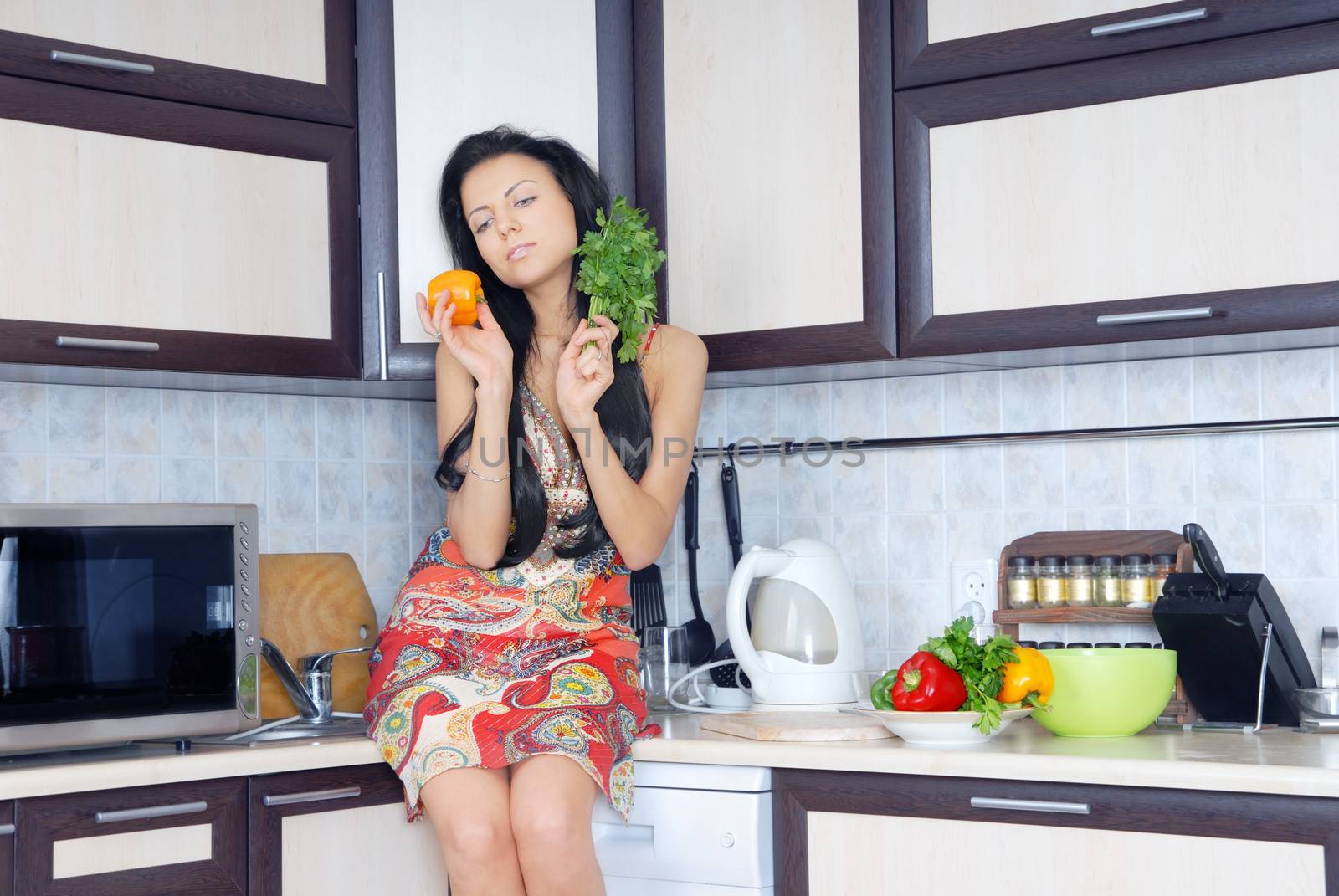 Photo of the pretty lady in the kitchen preparing salad