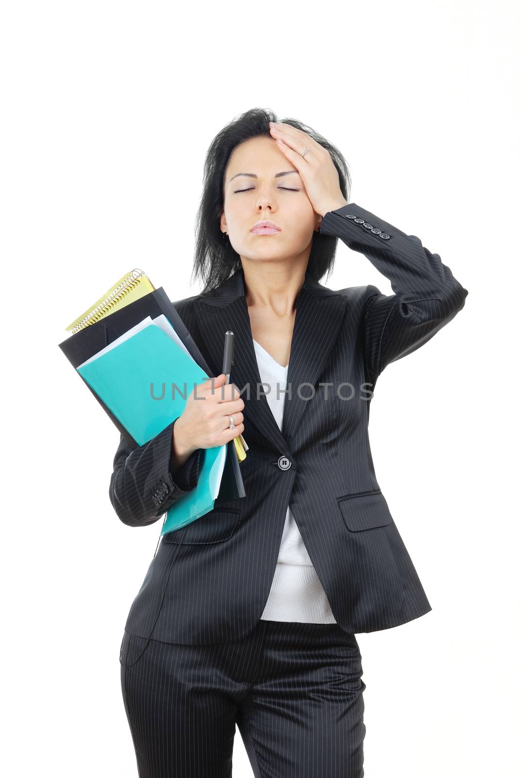 Thinking businesswoman with documents and pen and suffering from the headache