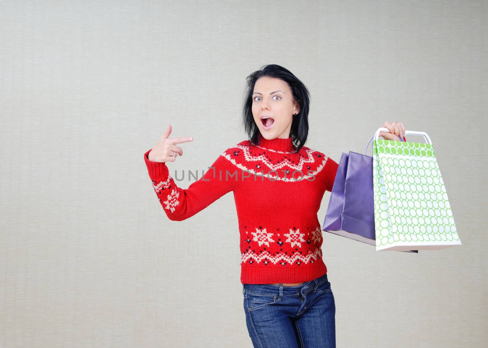 Glad woman showing the bags with gifts