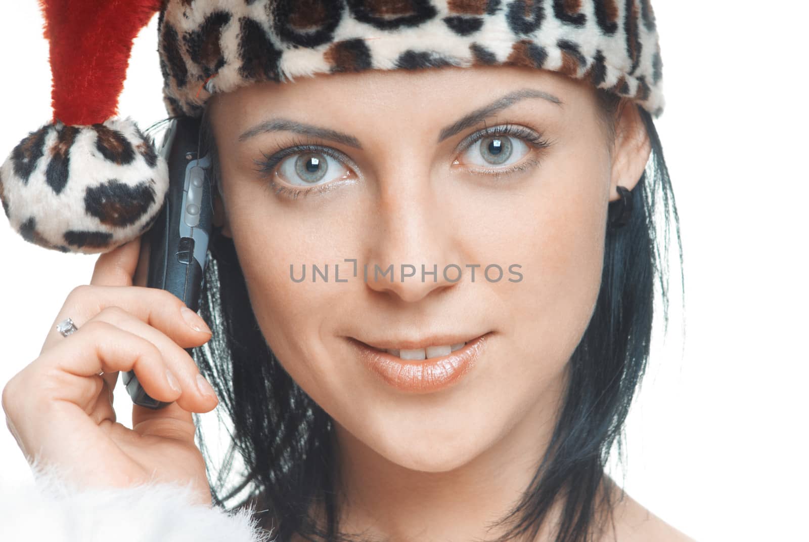 Woman in Santa Claus costume talking via cell phone on a white background