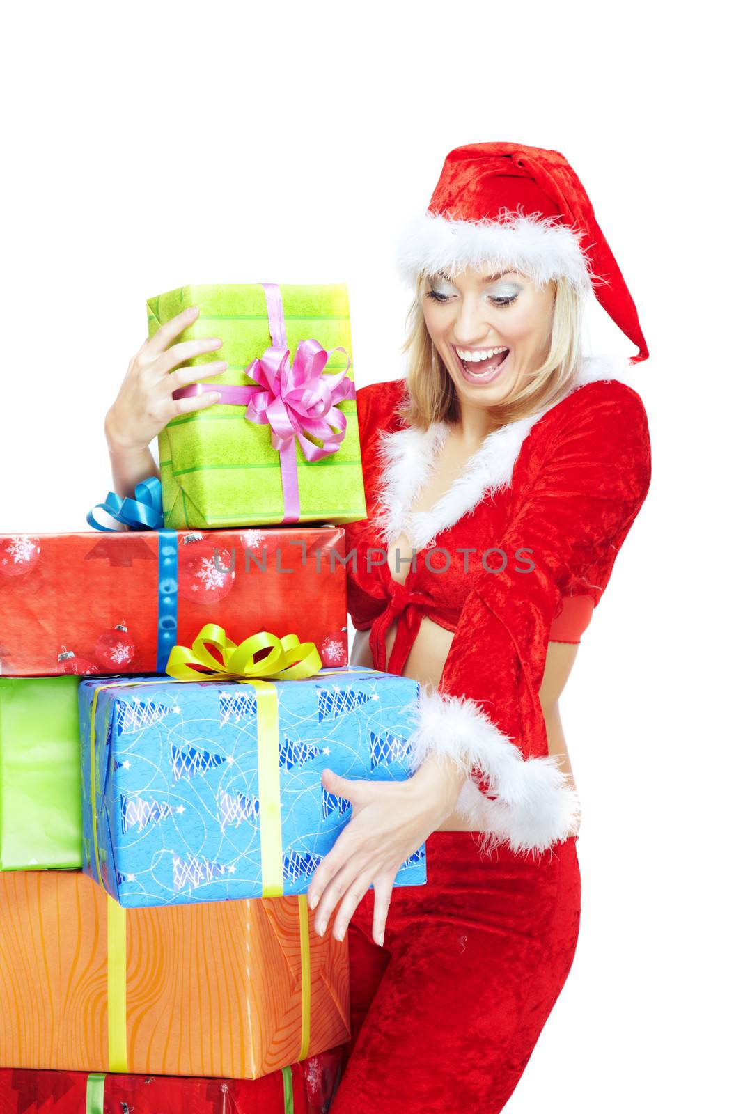 Happy lady in Santa Claus costume holding colorful gift boxes on a white background
