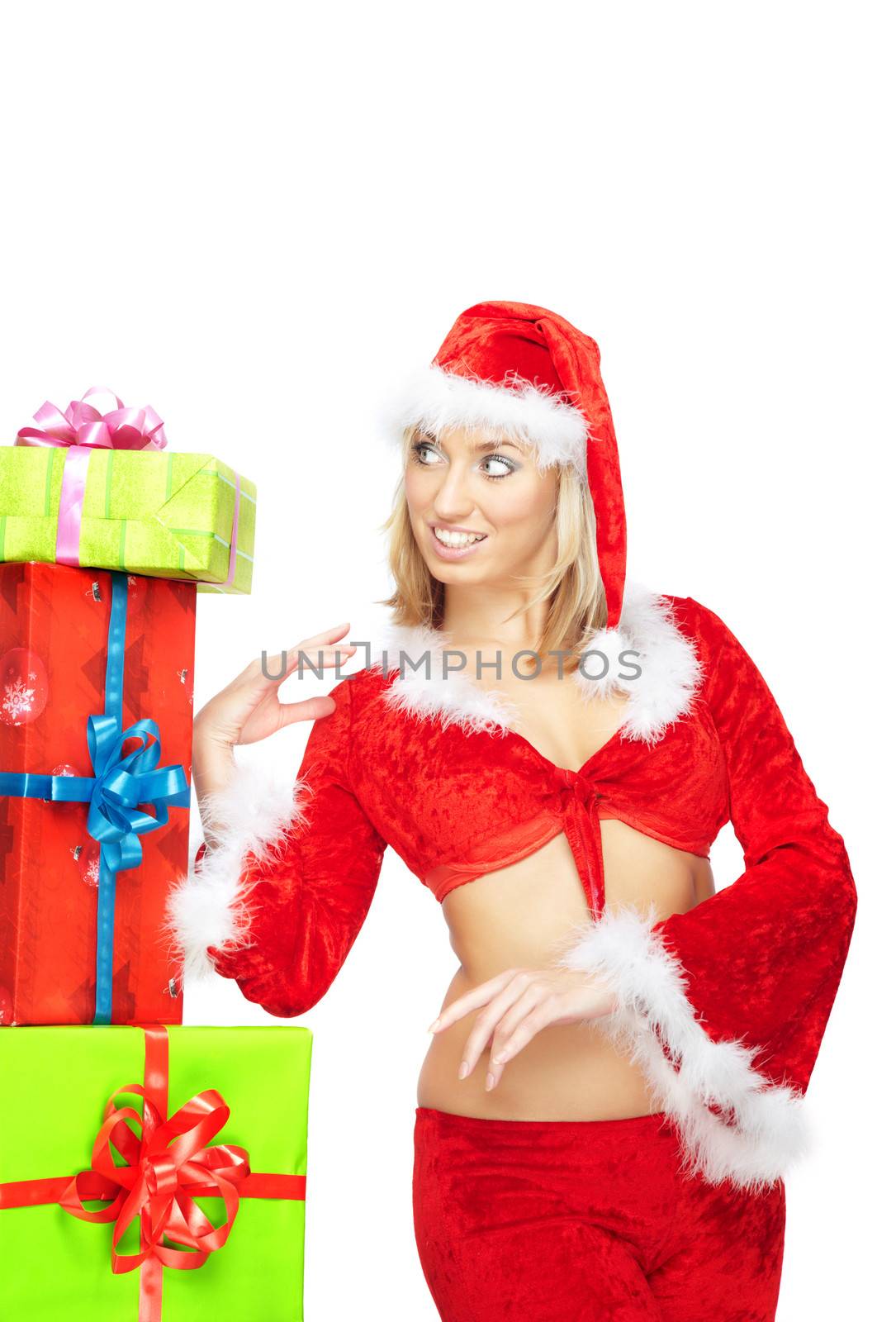 Smiling lady in Santa Claus costume standing near the Christmas gifts on a white background