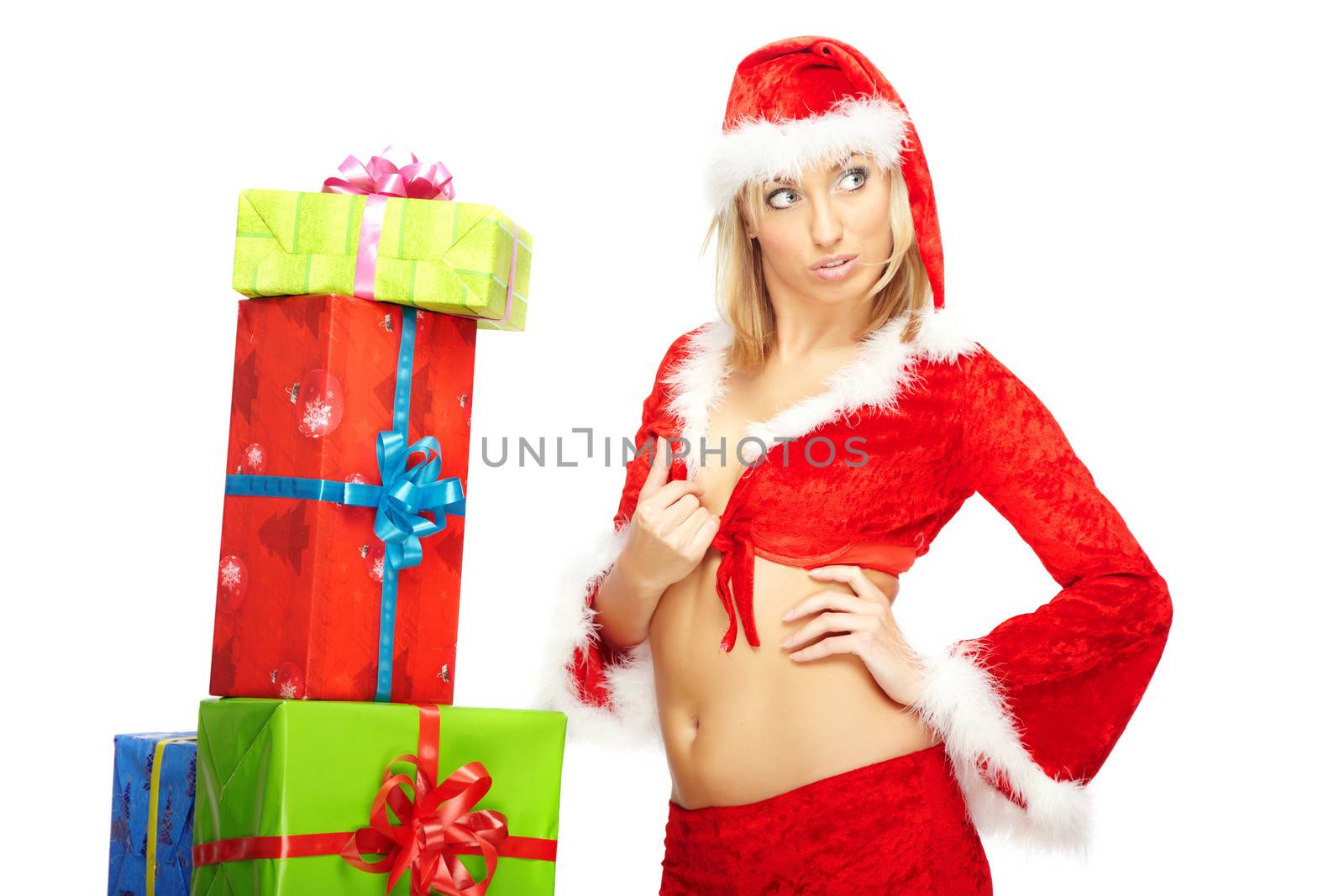 Stylish elegant lady in the red Santa Claus costume near the colored Christmas gift boxes