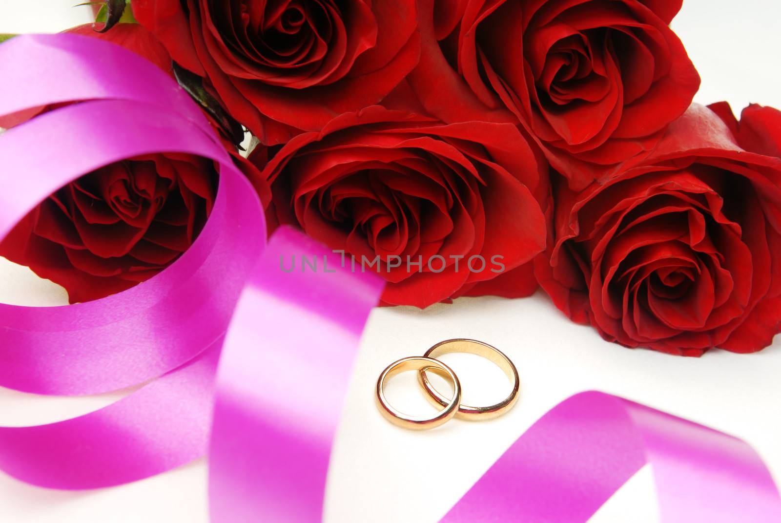 Wedding decoration including roses and golden rings