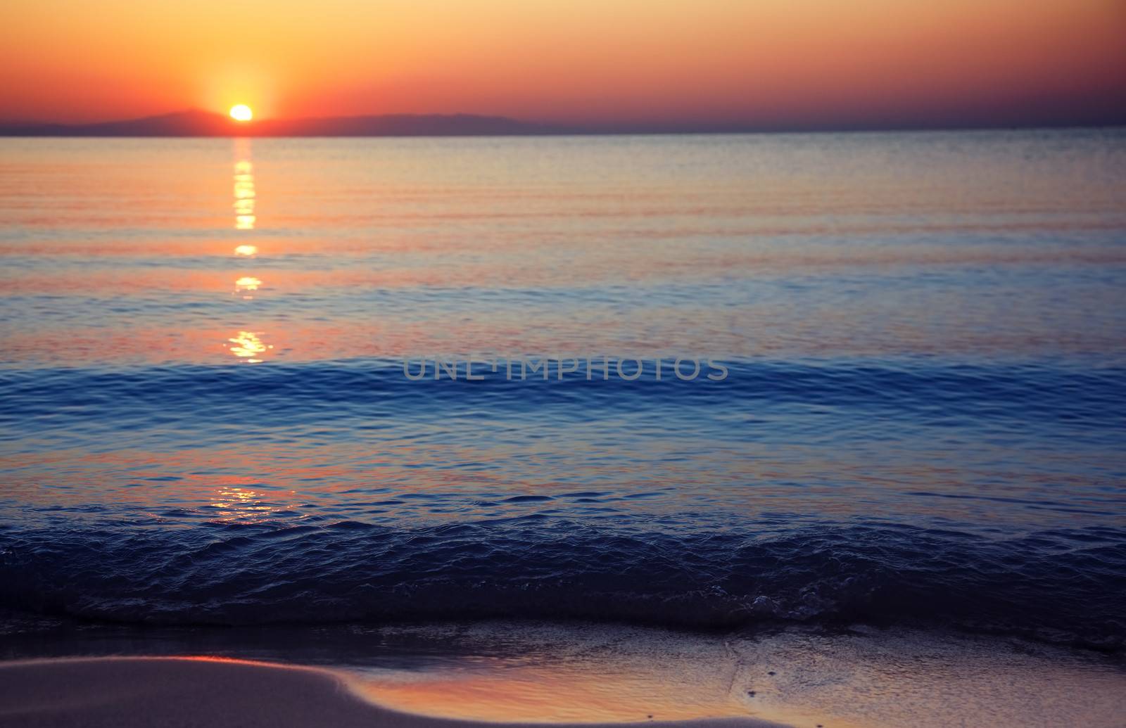 Seascape with sunrise at the horizon. Natural darkness and colors