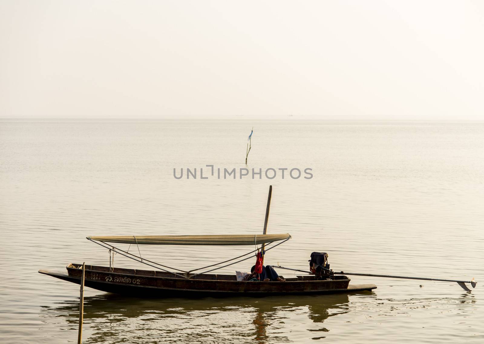 Fishing boat in the sea by gjeerawut
