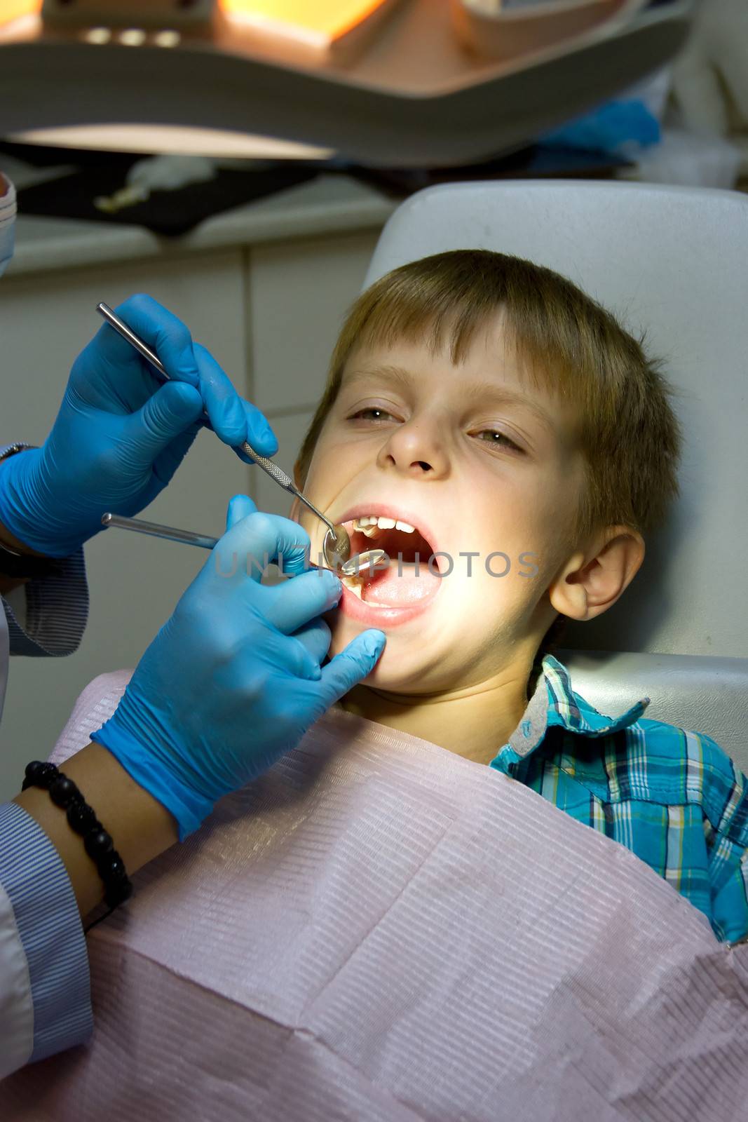 little boy with a doctor in dental surgery by victosha