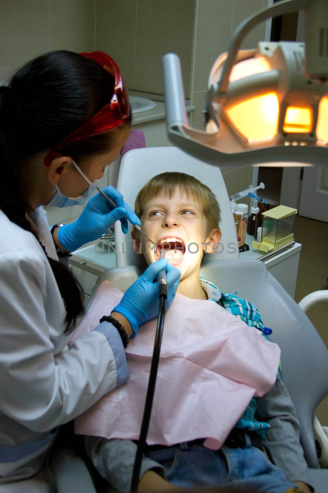 little boy with a doctor in dental surgery by victosha