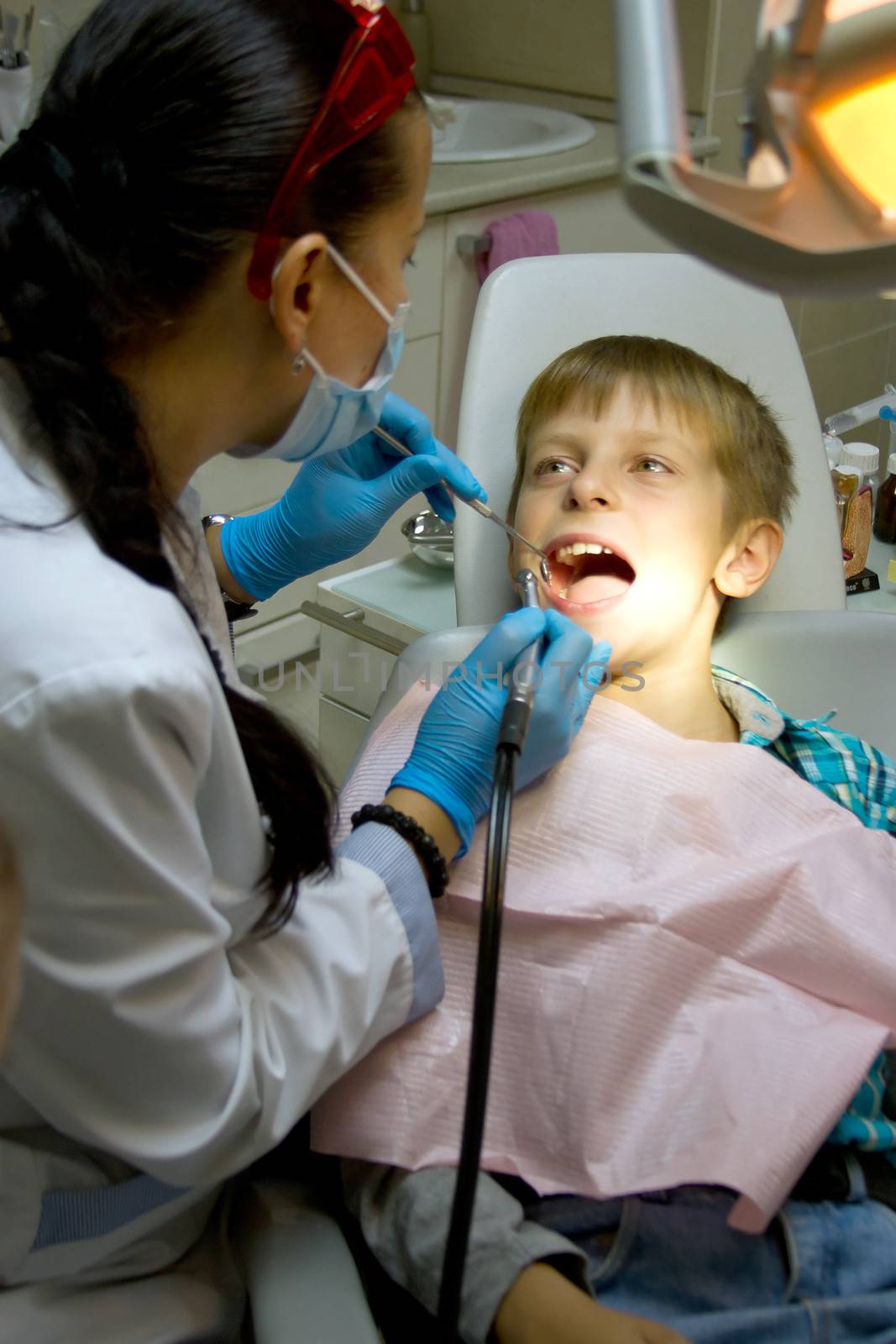 little boy with a doctor in dental surgery by victosha