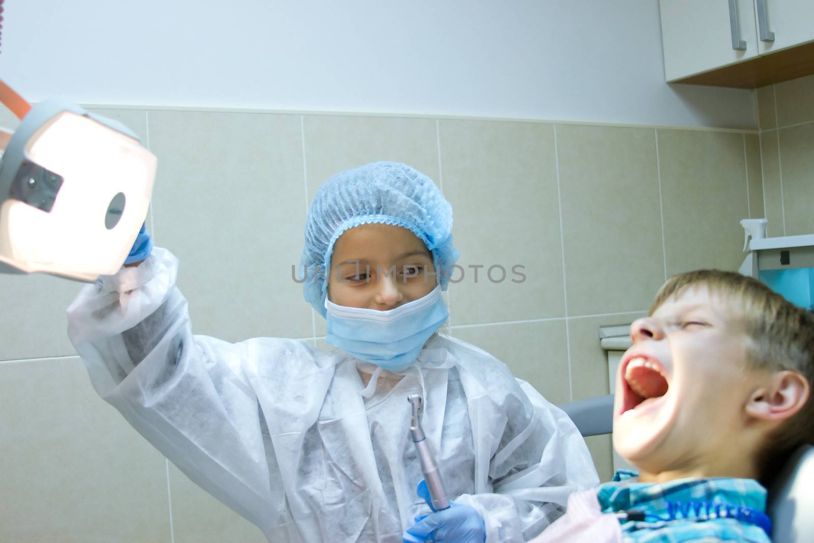 couple of kids playing doctor at the dentist by victosha