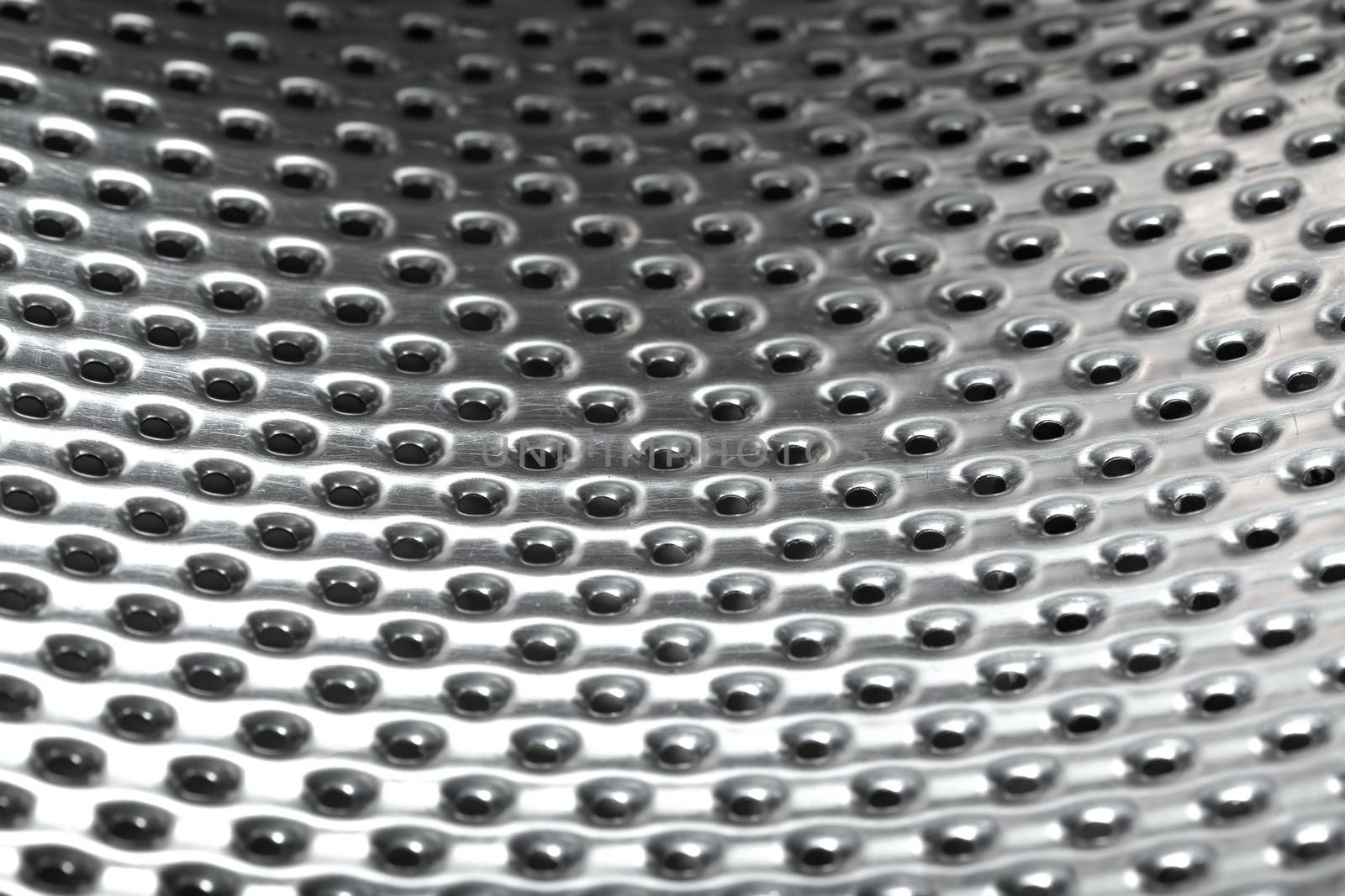 Close-up photo of the metal pattern with perforated holes