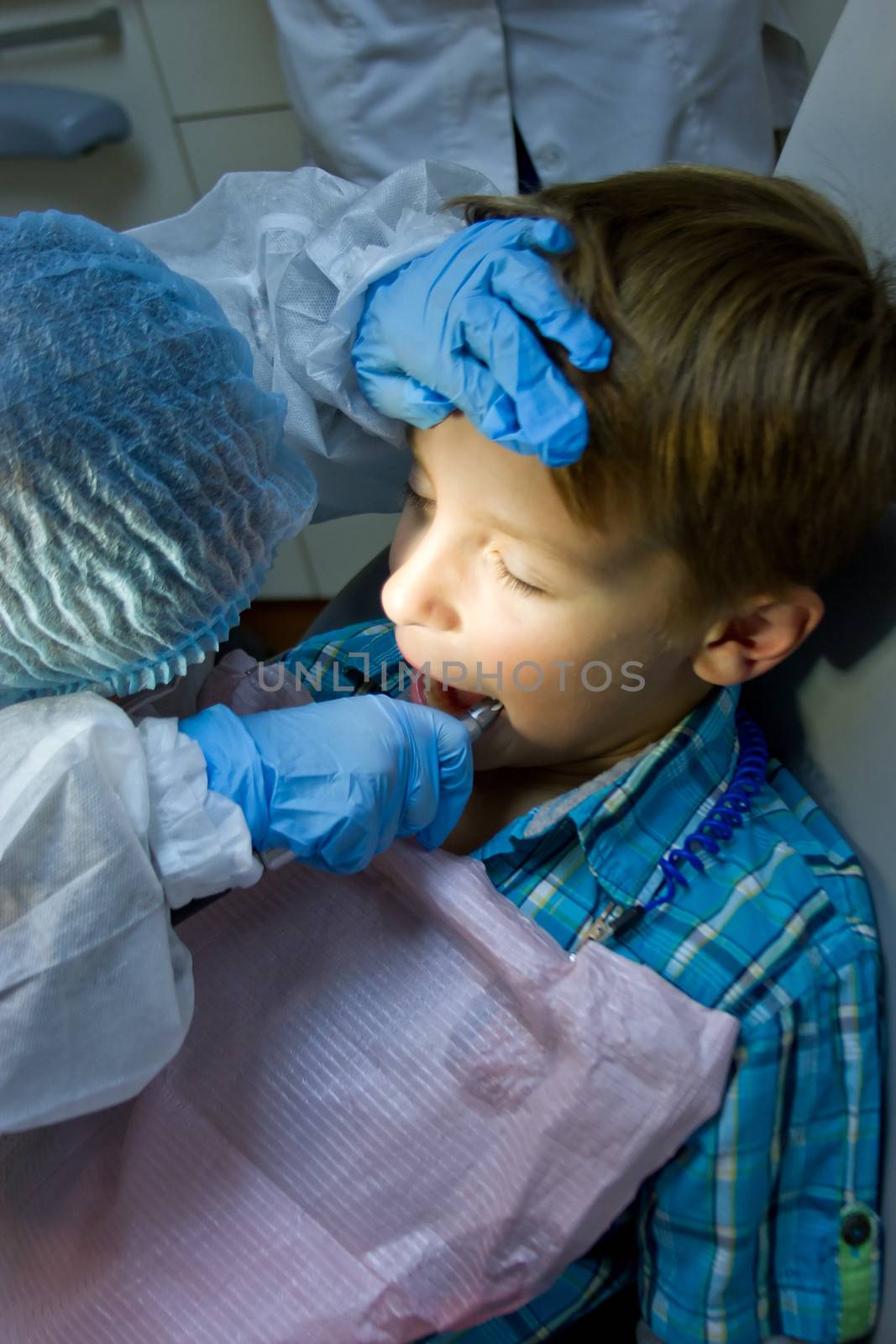 A couple of kids playing doctor at the dentist