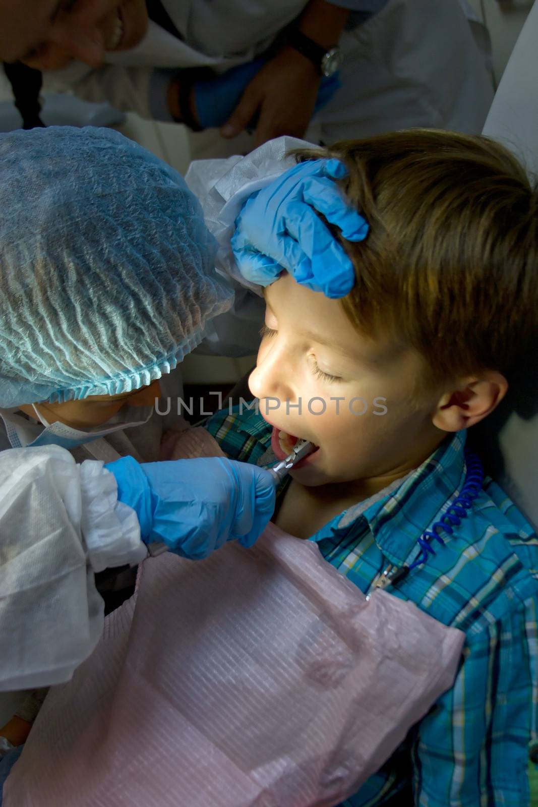 A couple of kids playing doctor at the dentist