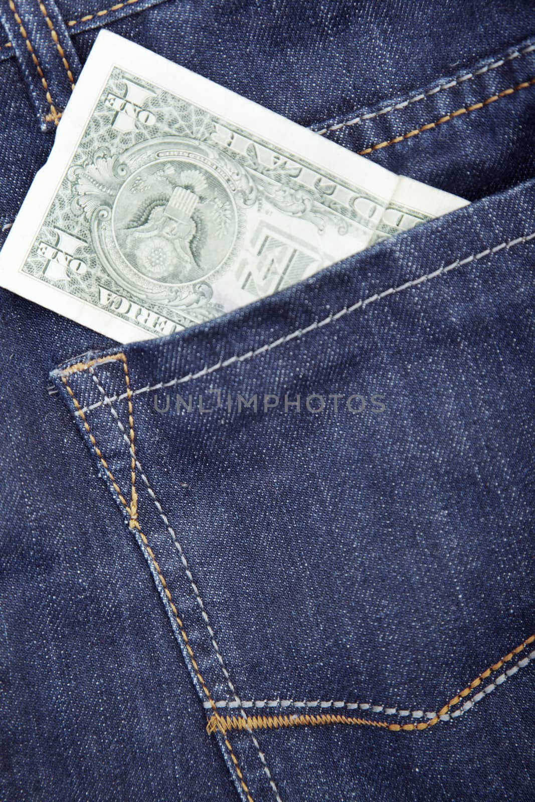 US dollar in the pocket of blue jeans. Close-up photo