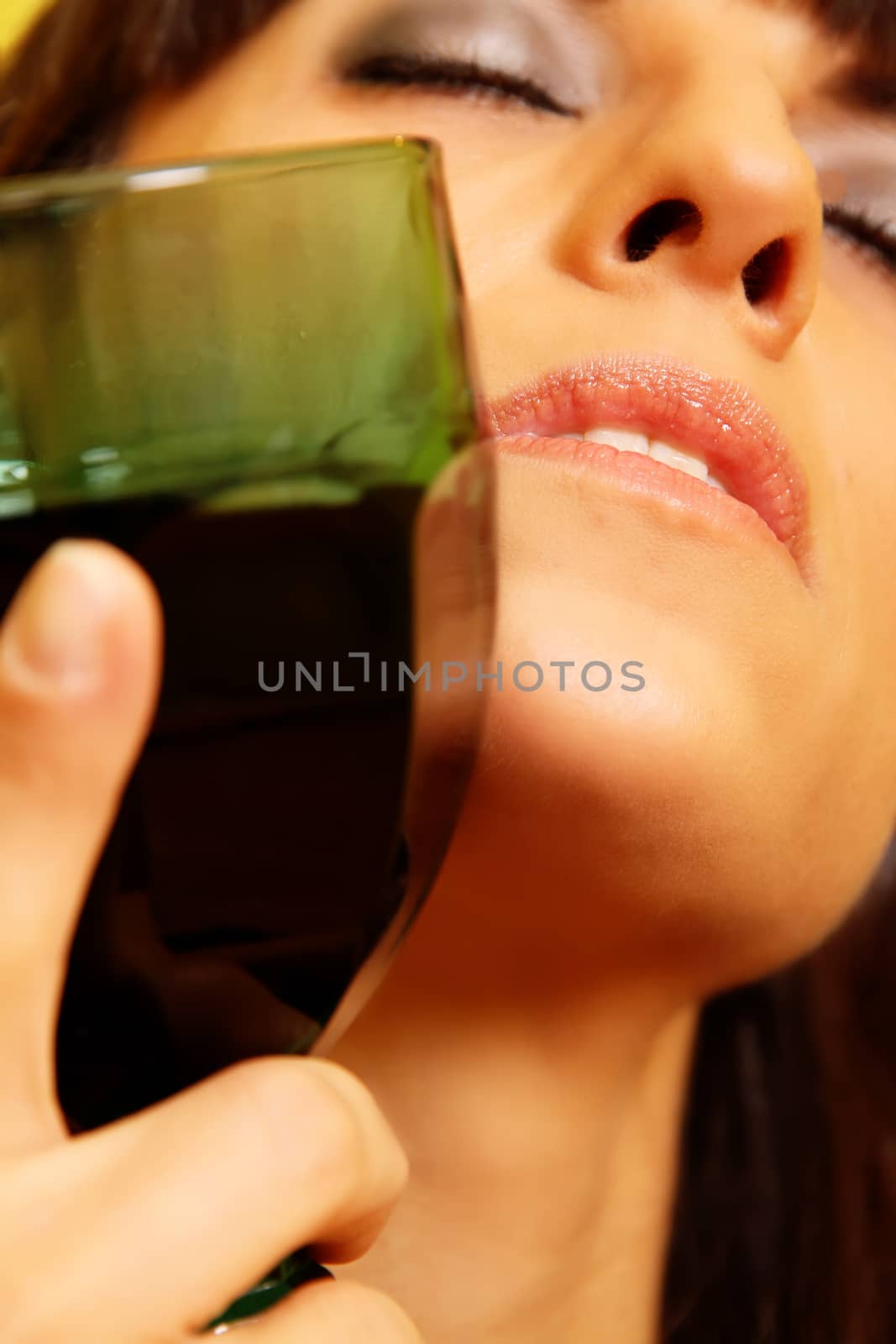 Closeup portrait of a latin woman holding a wine glass.