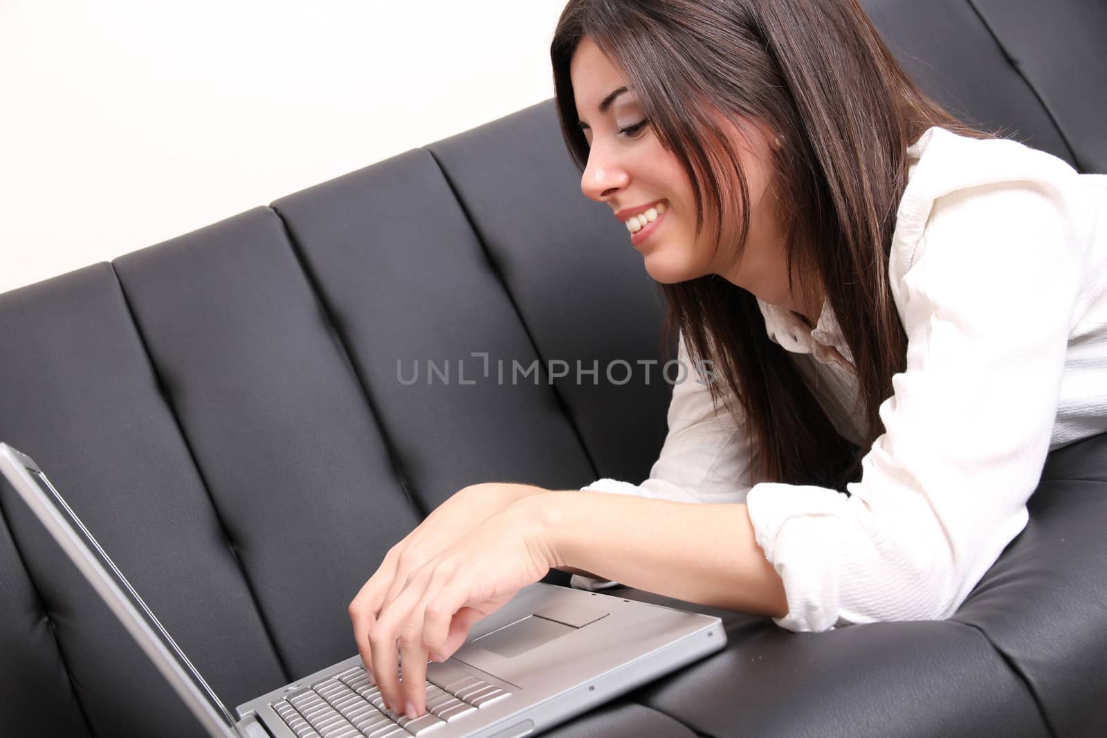 Young Hispanic Woman surfing on the Sofa by Spectral