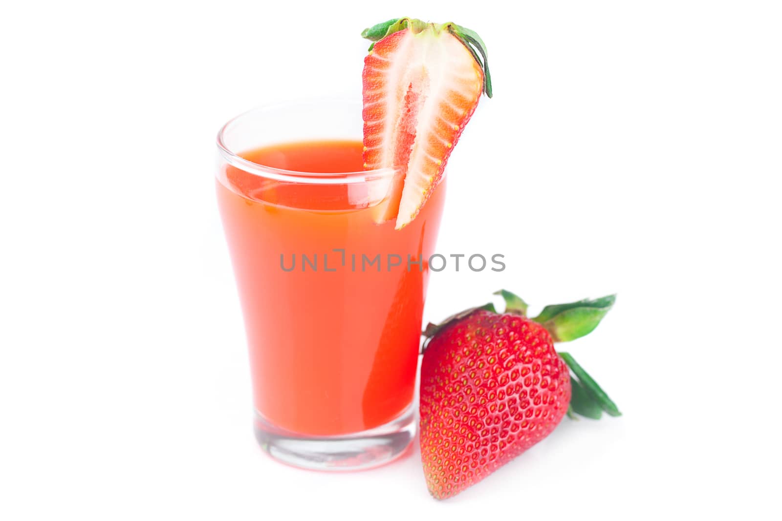 strawberry and a glass of strawberry juice isolated on white