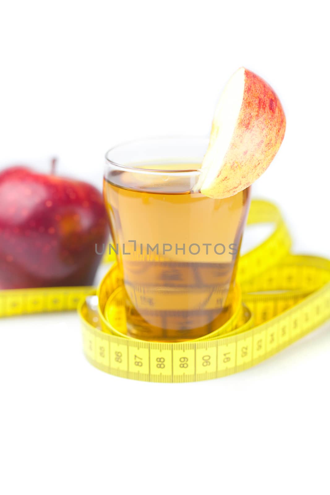 measuring tape,apples and glass of apple juice isolated on white by jannyjus
