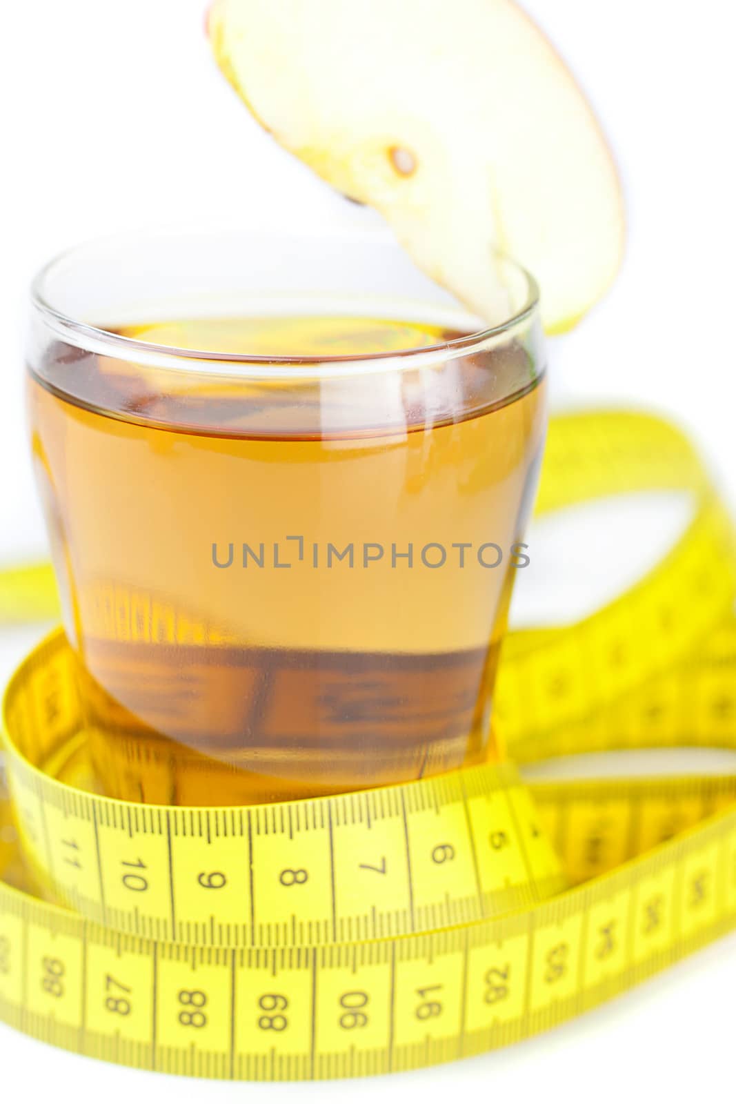 measuring tape,apples and glass of apple juice isolated on white