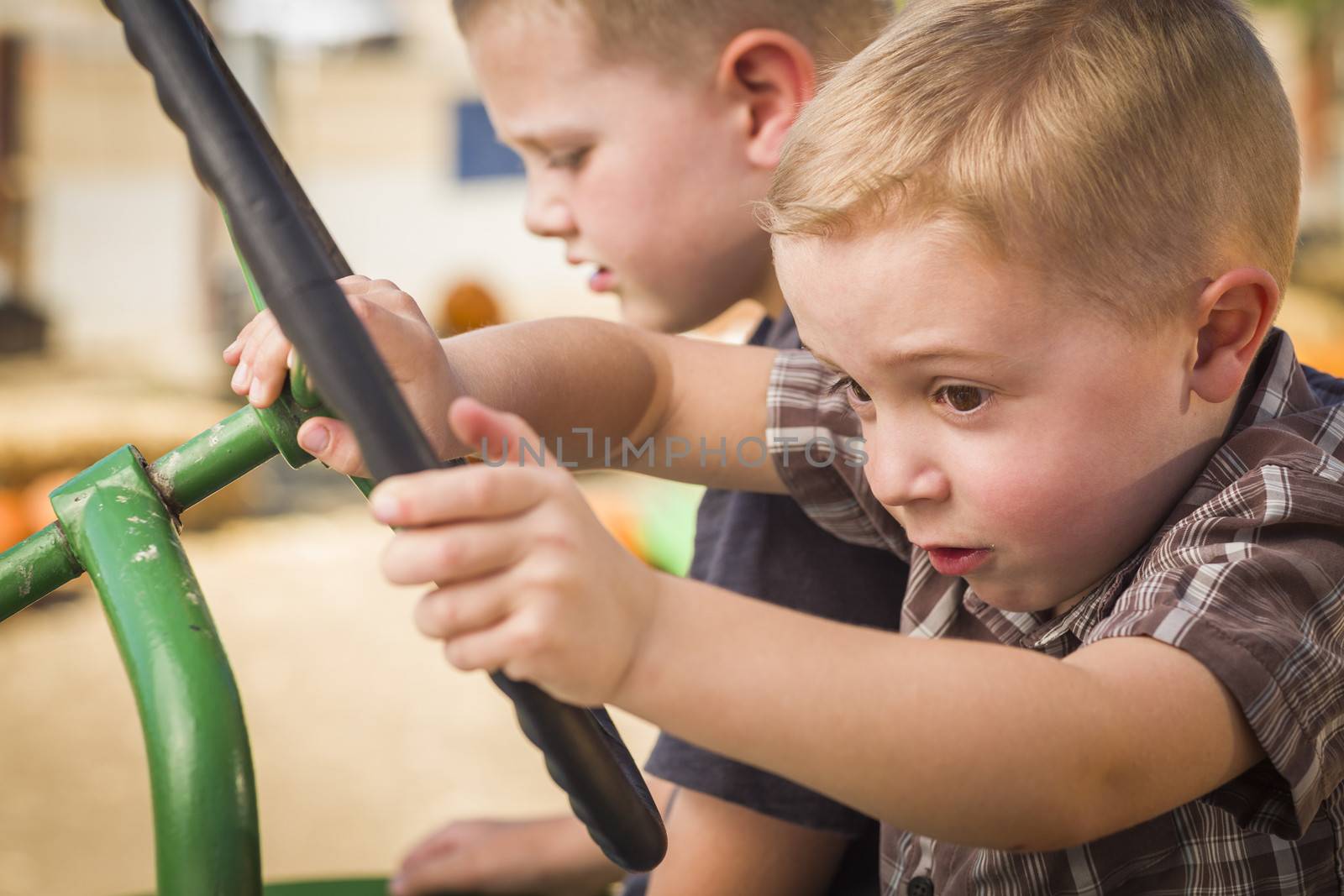 Adorable Young Boys Playing on an Old Tractor Outside by Feverpitched