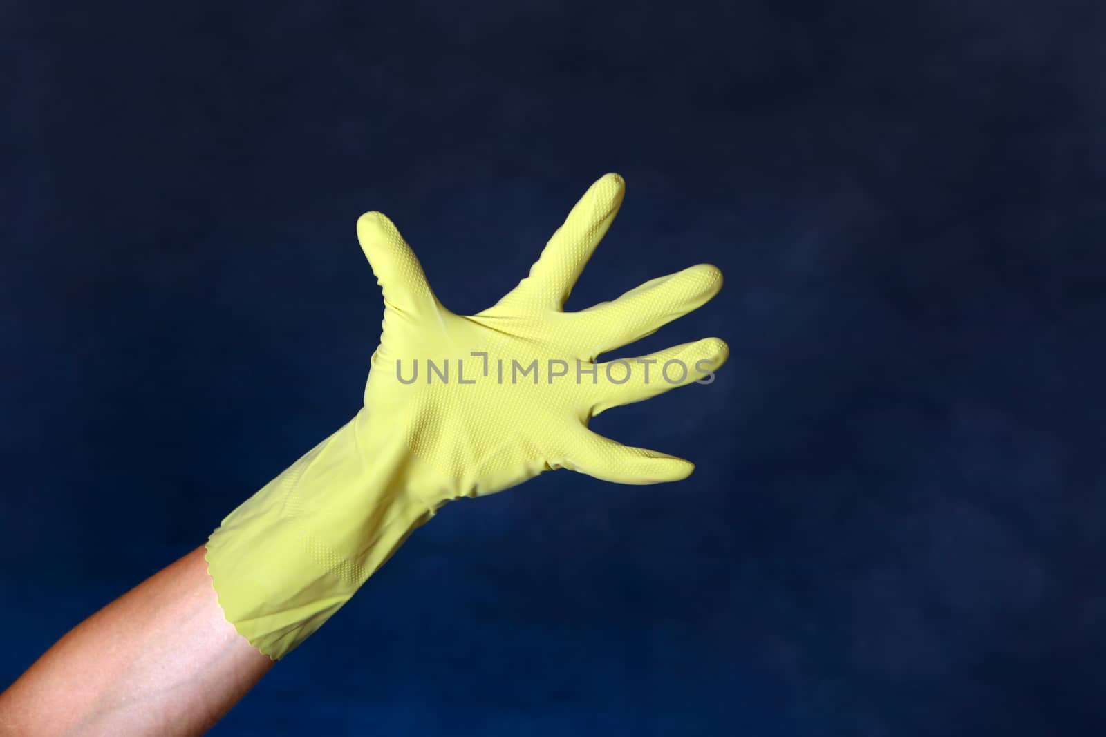 Hand in Rubber Glove on the dark background