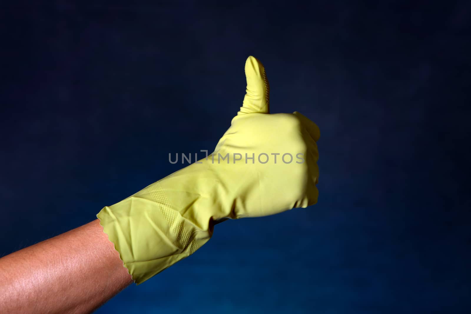 Hand in Rubber Glove with OK gesture on the dark background