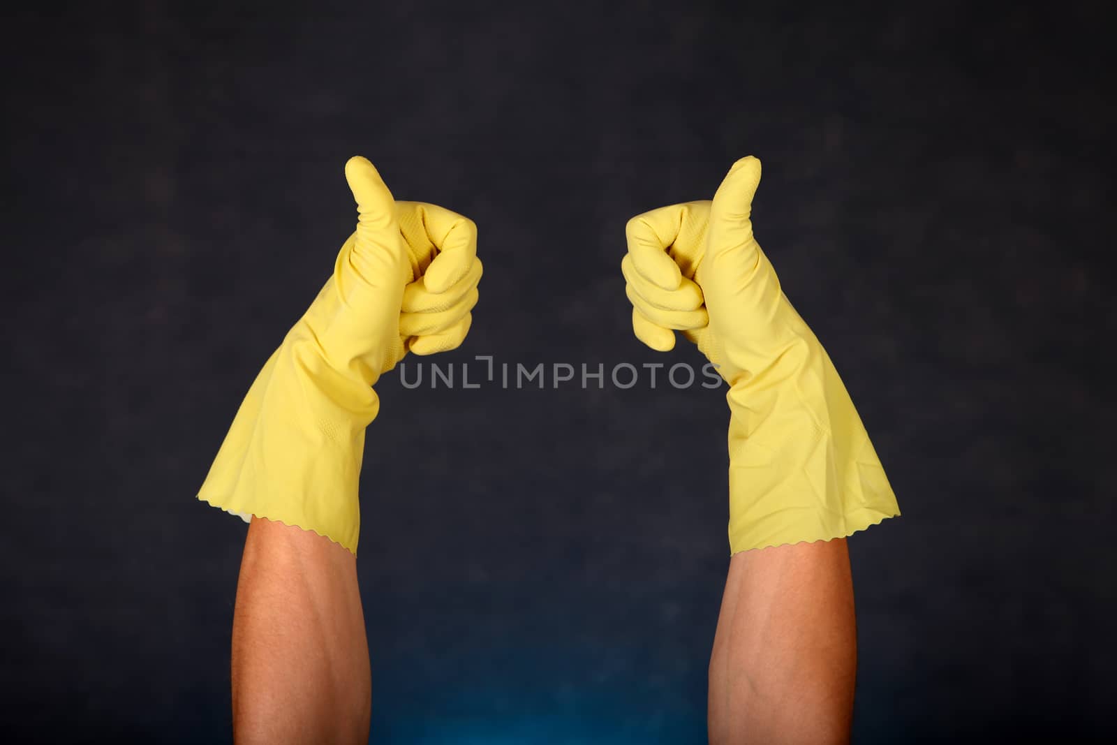 Two Hands in Rubber Gloves with Thumb Up gesture on the dark background