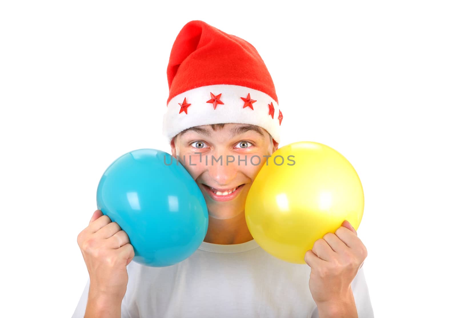 Cheerful Teenager with Two Balloons in Santa's Hat Isolated On The White Background