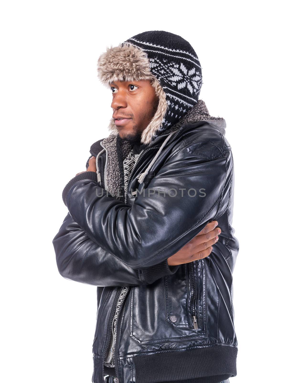 Young African-American wearing winter clothing but feeling cold in a white background