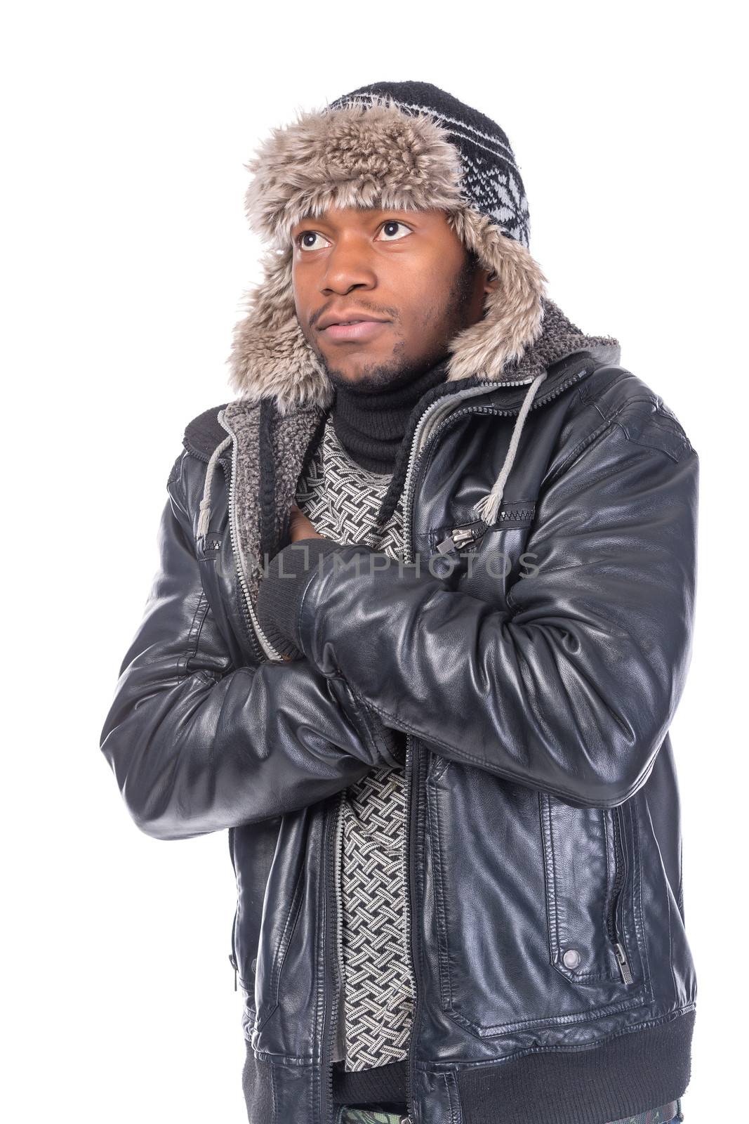 Young African-American wearing winter clothing but feeling cold in a white background