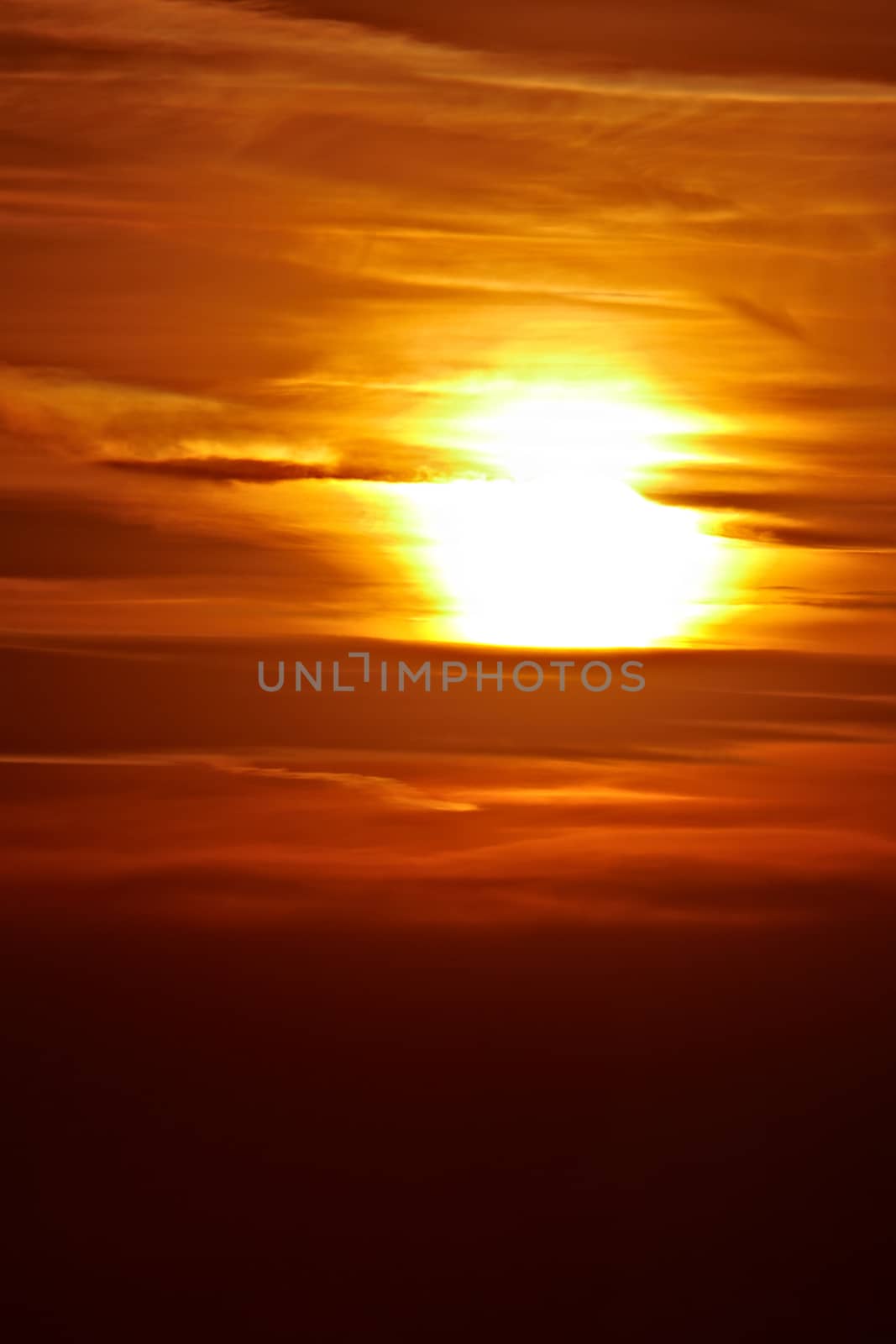 Setting sun in cloudy sky