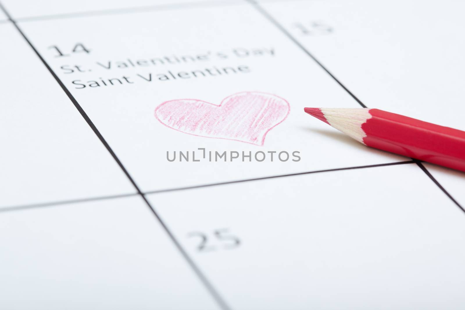 Red pencil on a calendar with Saint Valentine Day