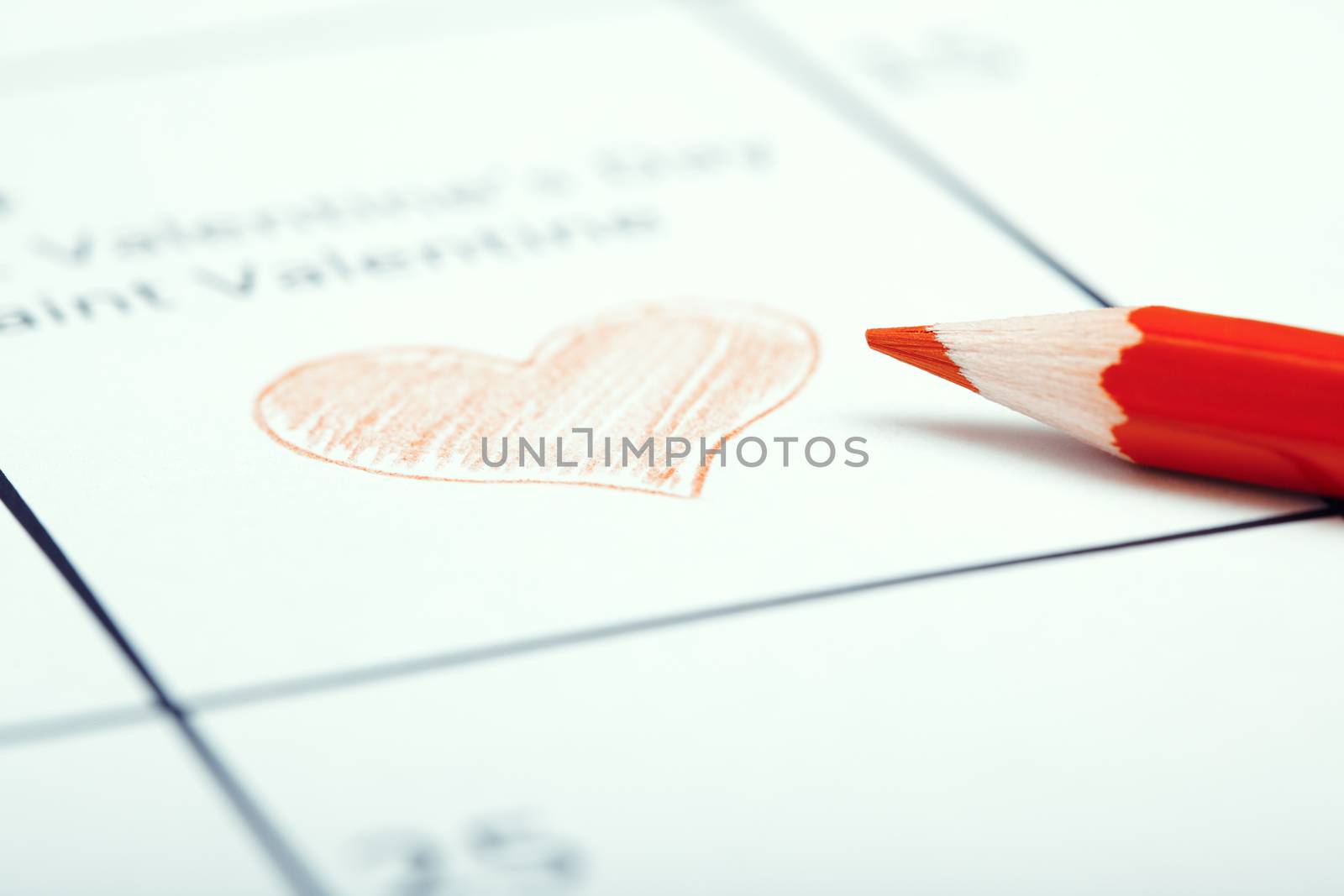 Red pencil on a calendar with Saint Valentine Day