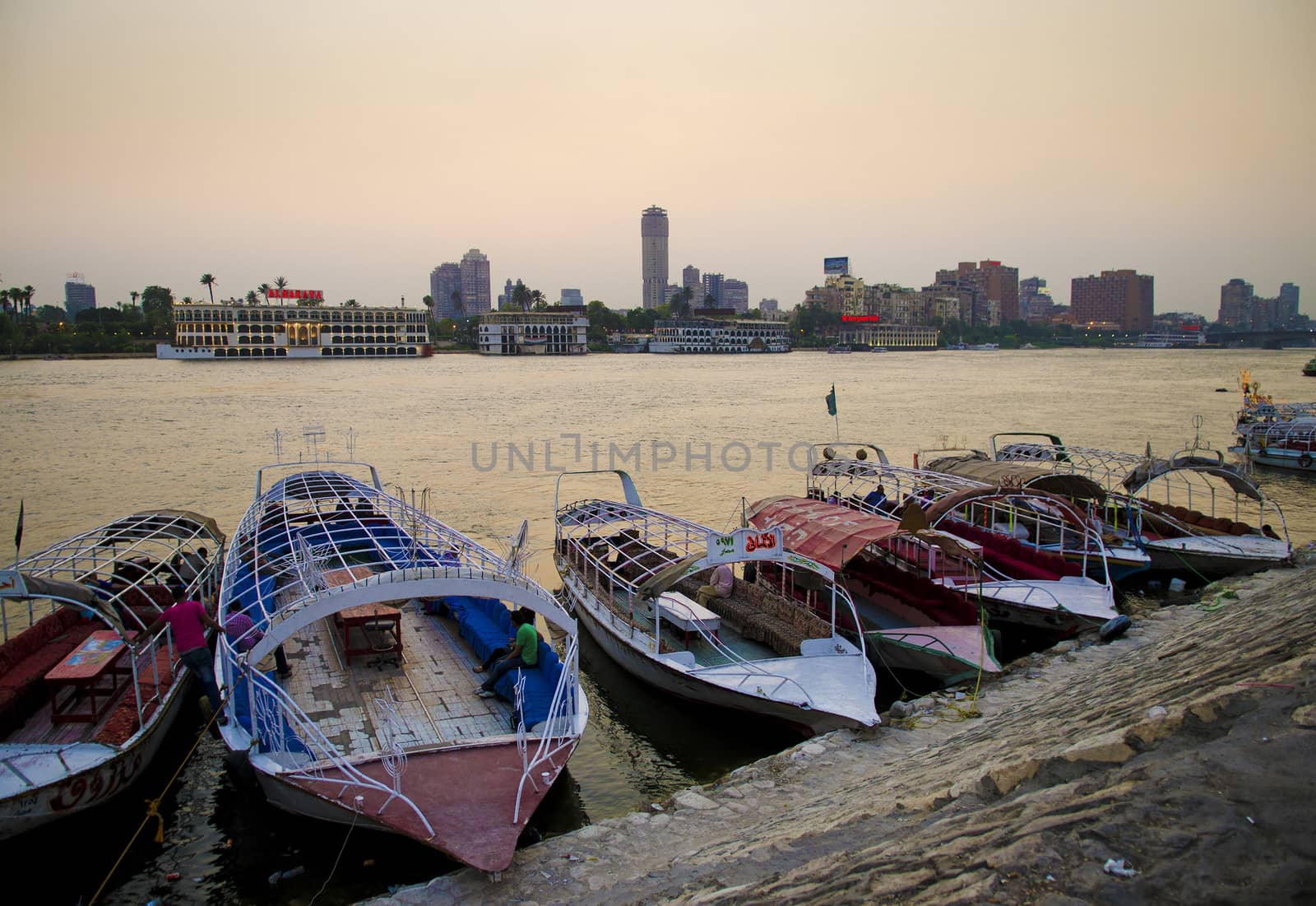 nile river with boats in cairo egypt by jackmalipan