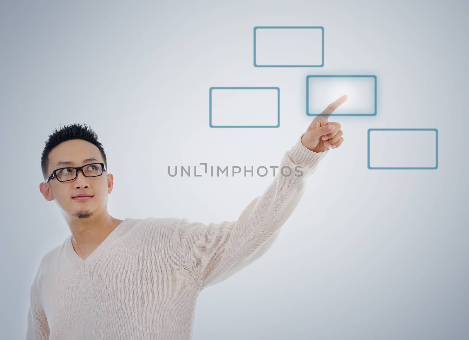 Asian man finger touching virtual transparent screen button, isolated on blue background. Asian male model.