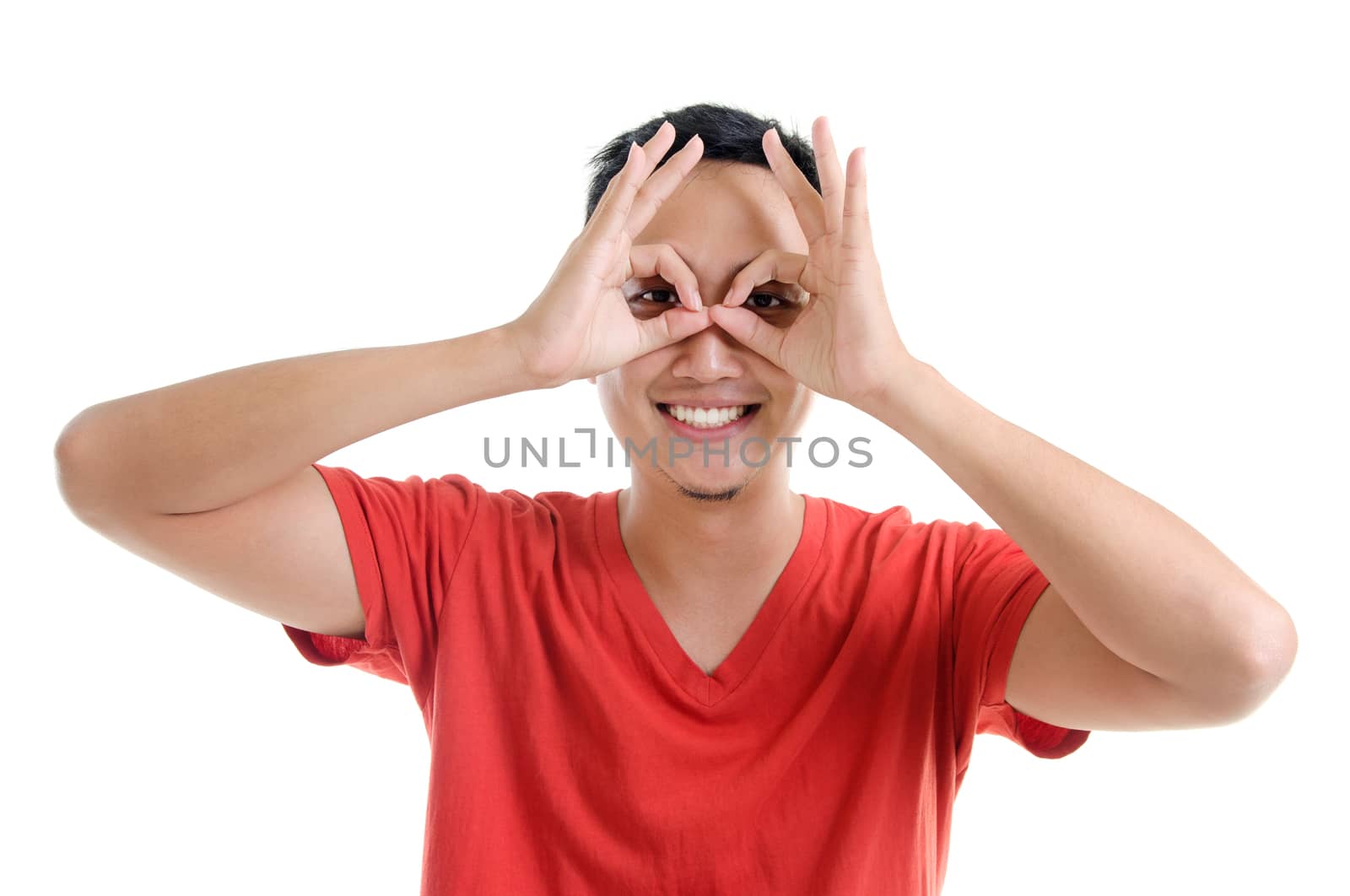 Asian male focused by hand hole. Portrait of Asian man standing isolated on white background.