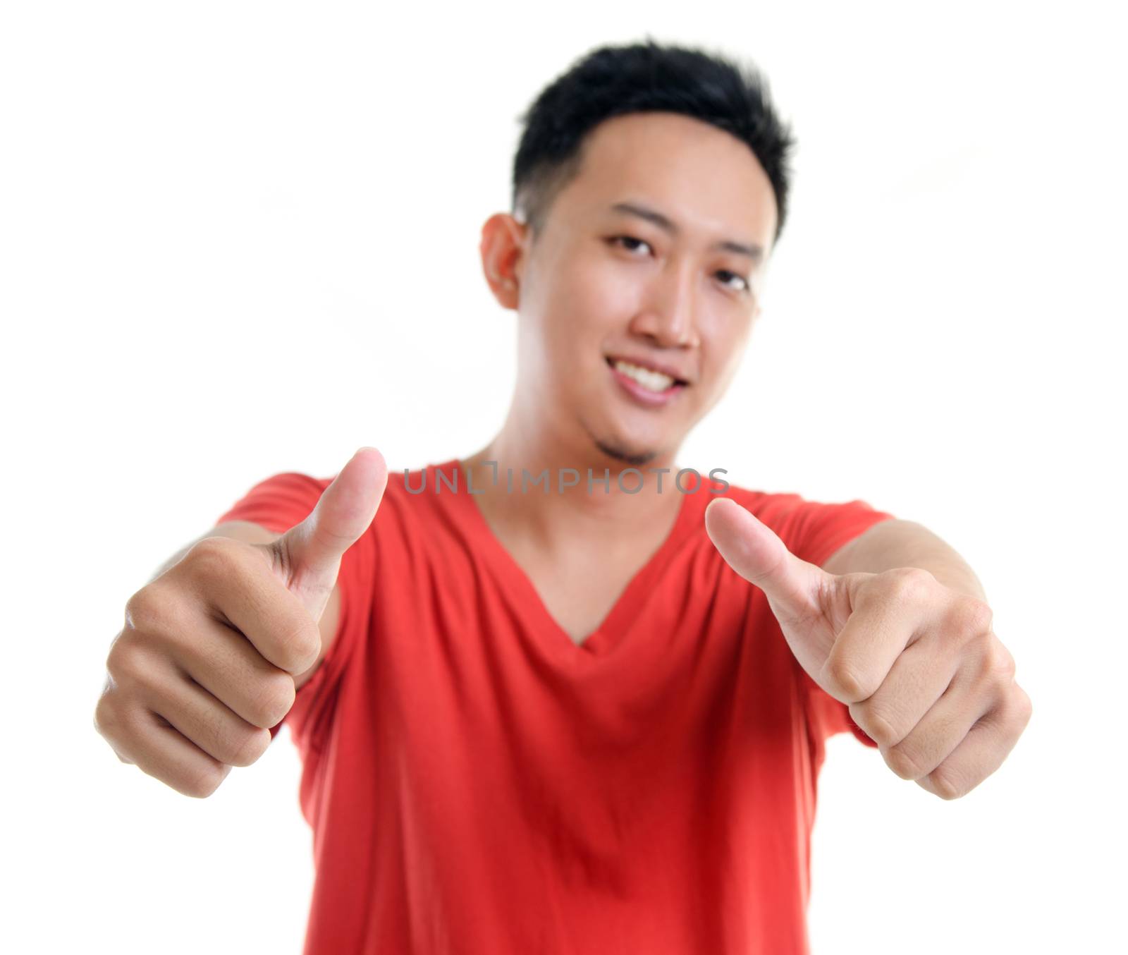 Thumb up cool young Southeast Asian man isolated over white background