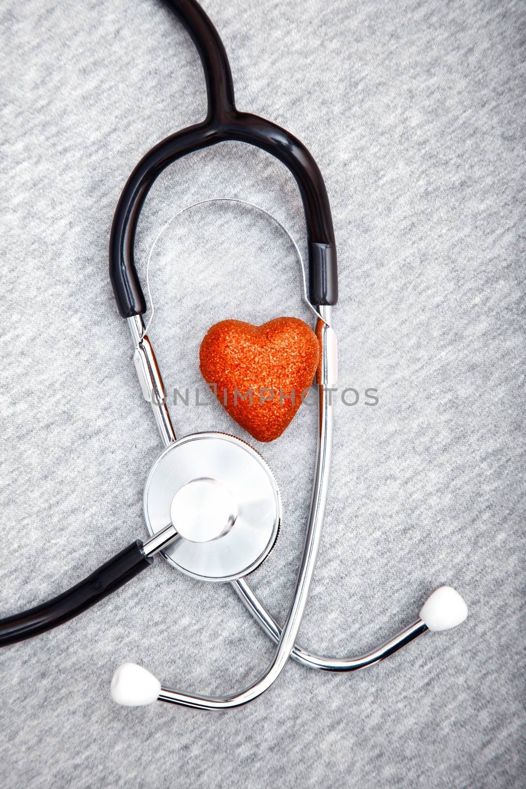 Medical stethoscope and heart on a blue textured background