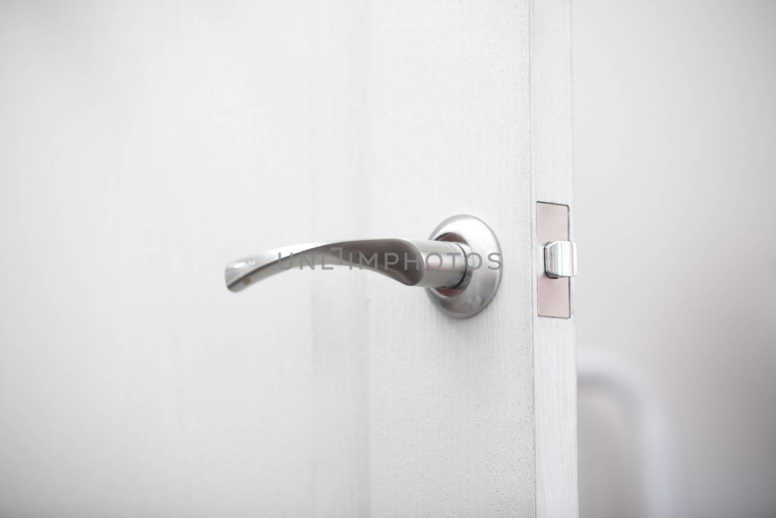 Close-up view on the wooden door with metal handle