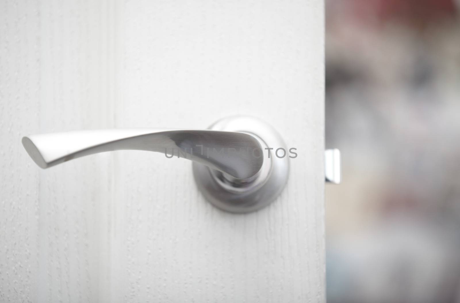 Close-up view on the wooden door with metal handle