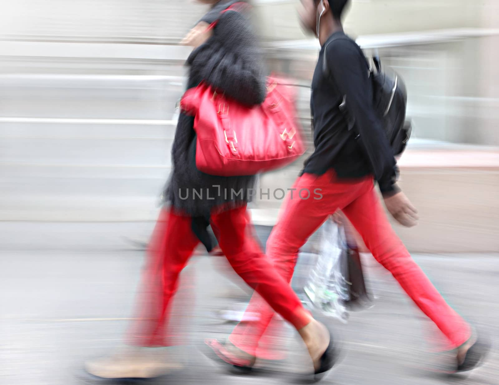 Young people at rush hour walking in the street. Intentional  motion blur