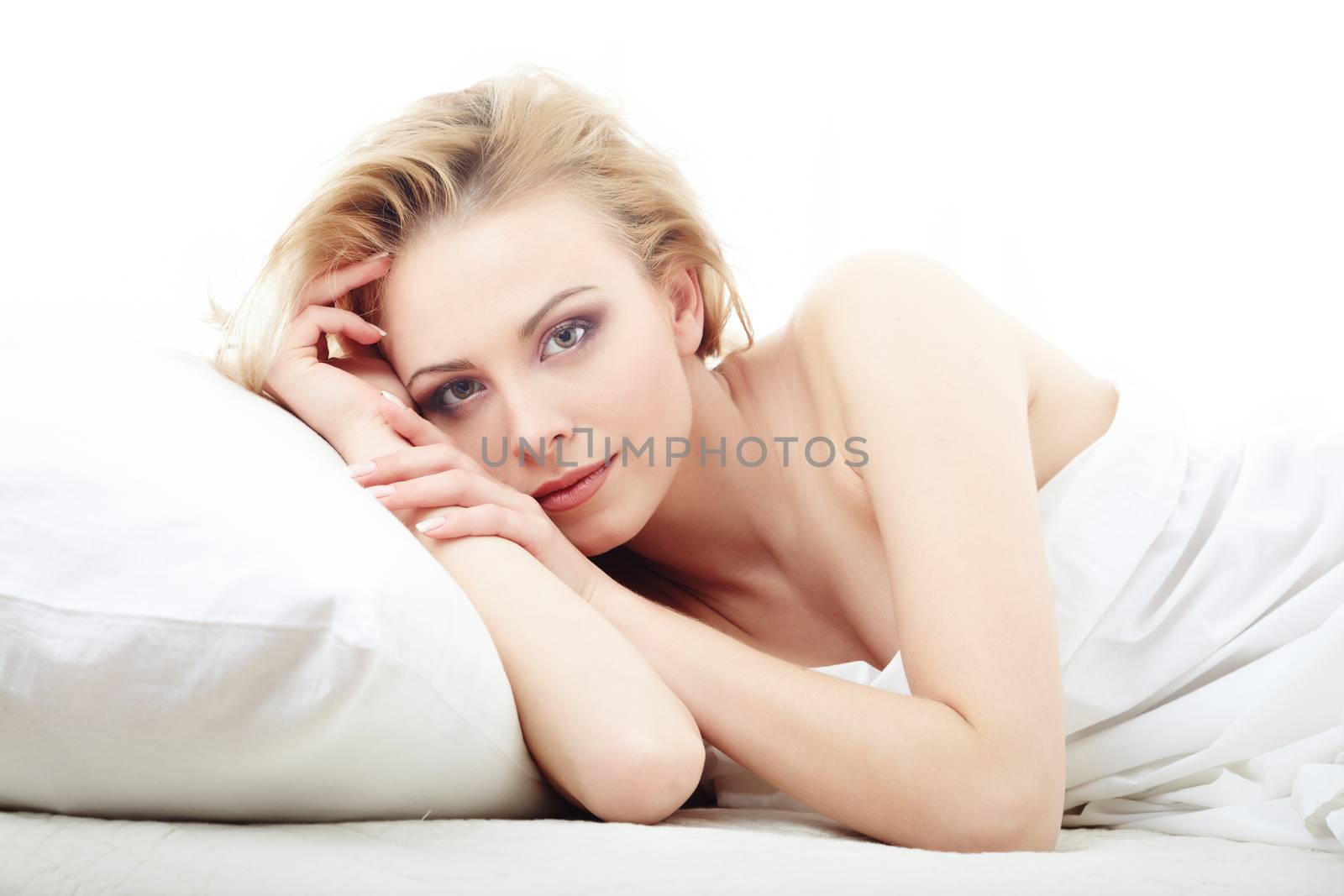 Resting lady laying on the bed on a white background