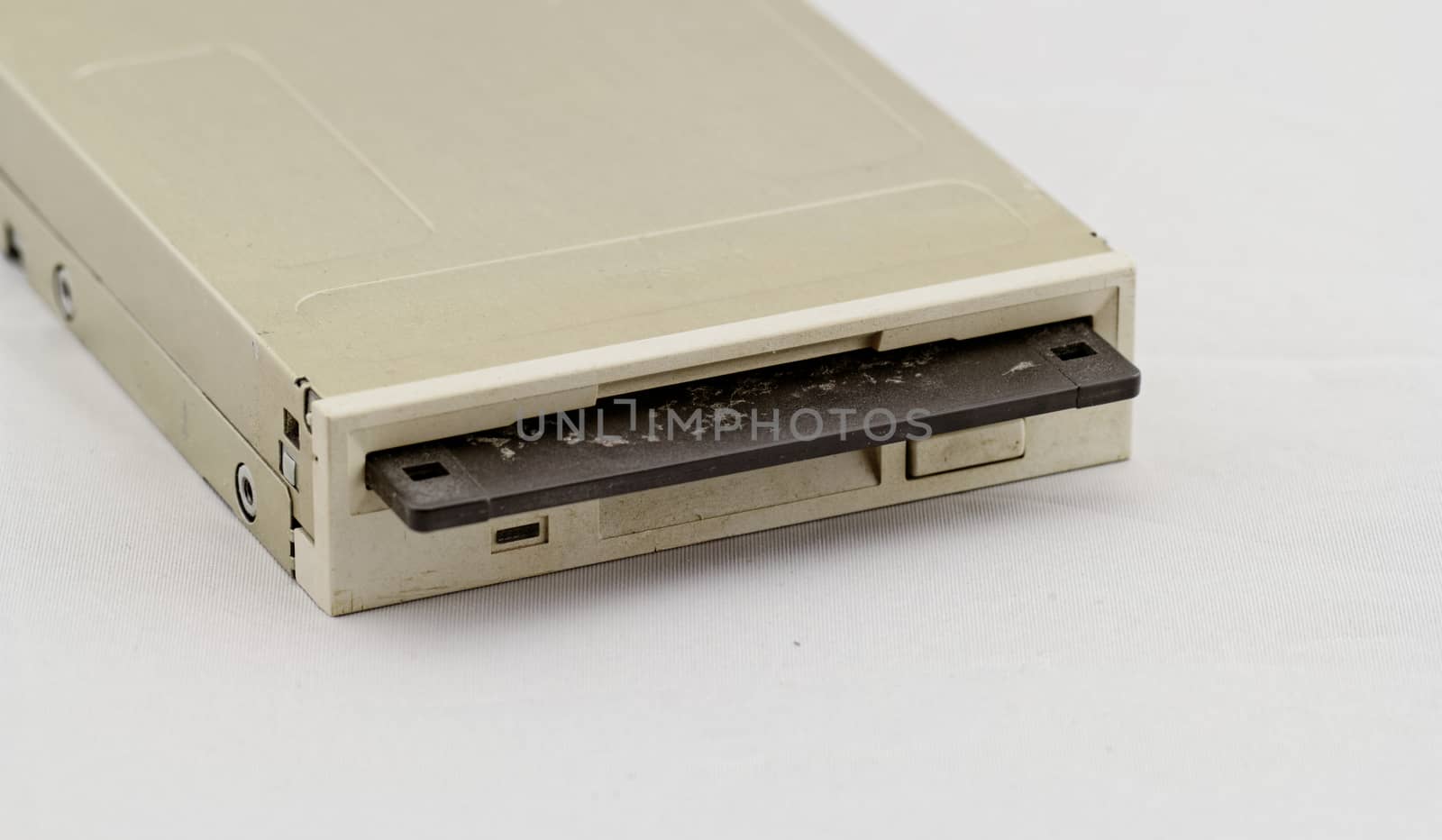 Floppy disk drive and diskette on white background
