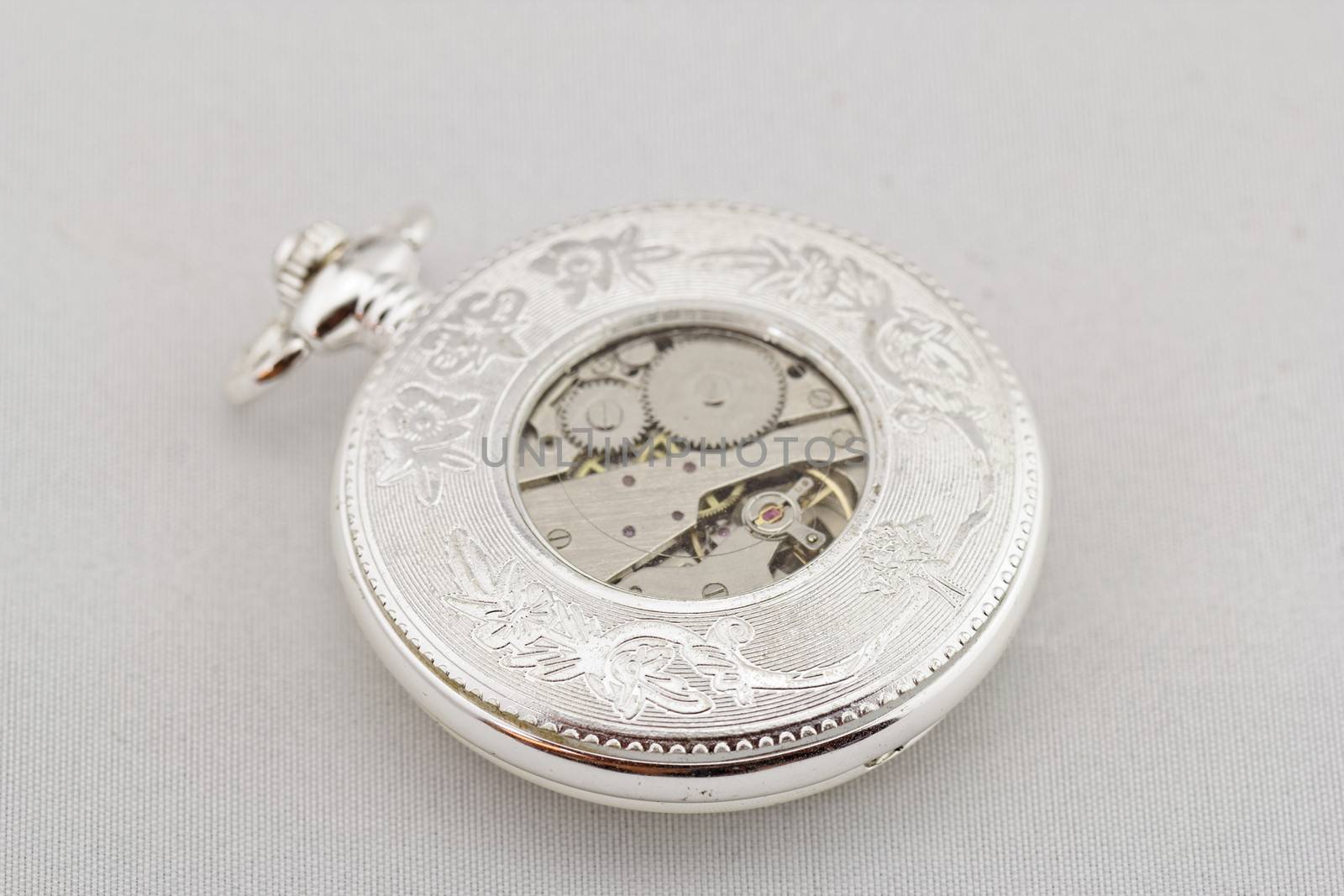 Part of a antique mechanical pocket watch on white background