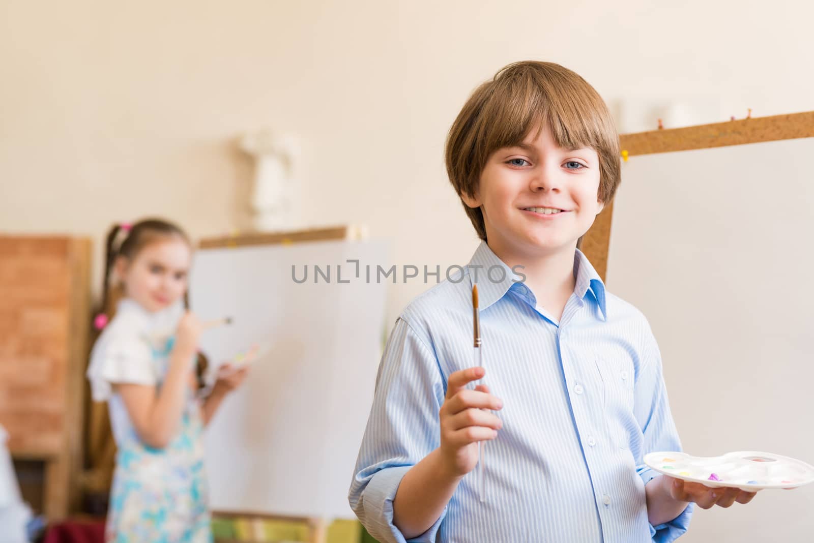 portrait of a boy standing next to his easel, a drawing lesson