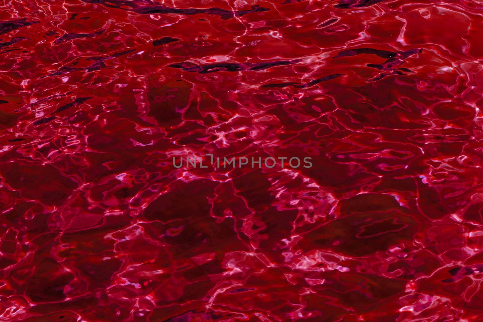 red abstract background of wavy water surface