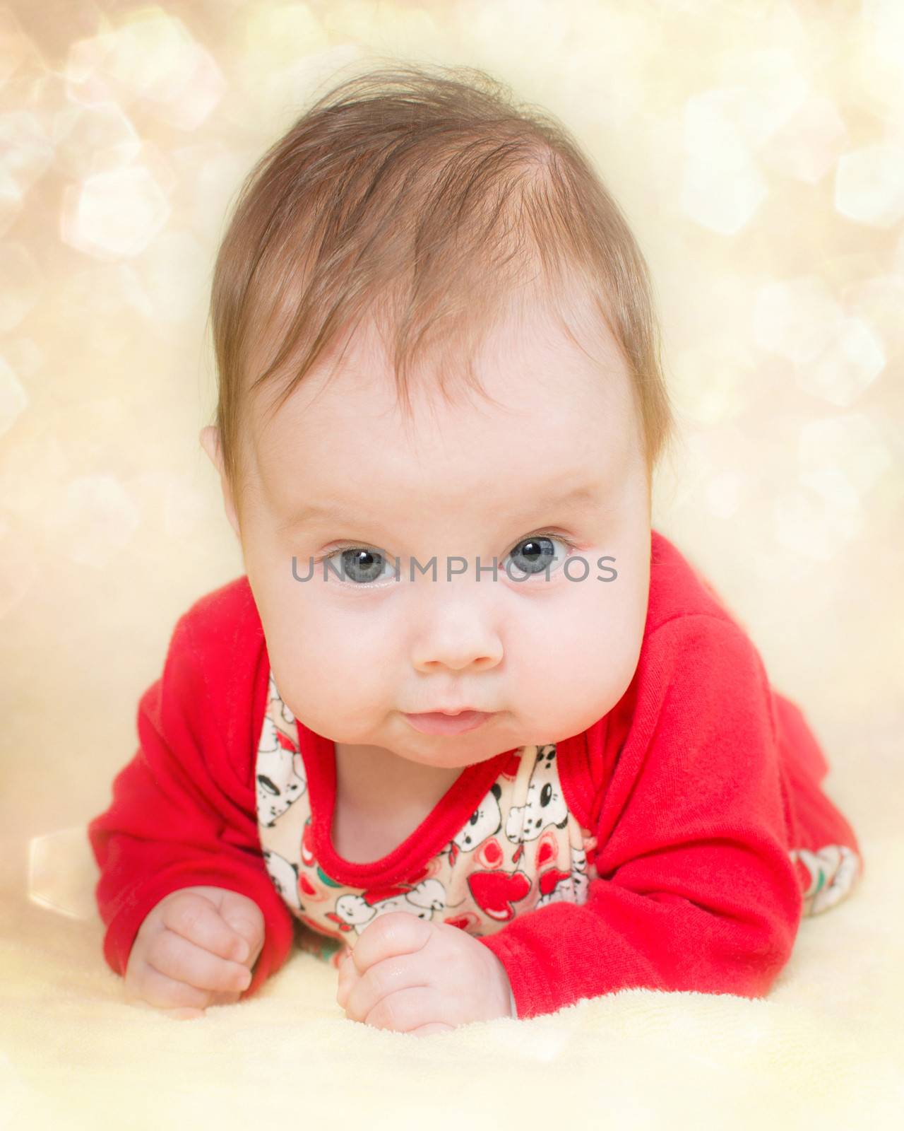 4 months old baby girl on a glitter bokeh background