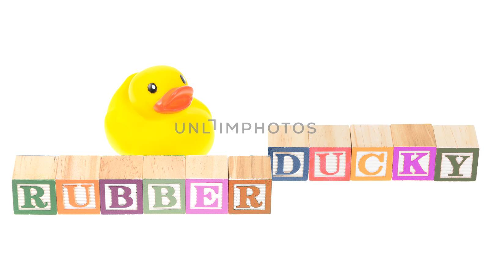 Baby blocks spelling rubber ducky with a rubber duck. Isolated on a white background